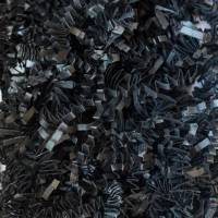 Close-up of black crinkle cut paper shred, deep black zig-zag paper strands for gift basket and box fill