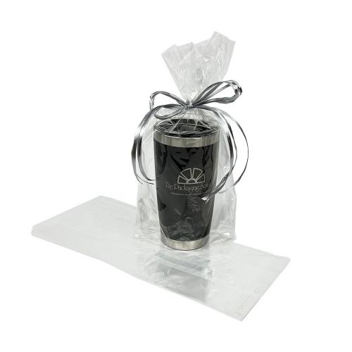 Clear cellophane side-gusset bag holding a stainless travel tumbler tied with silver ribbon, beside an empty flat bag