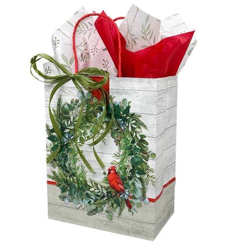 White kraft paper shopping bags with green wreath and red cardinal, red twisted handles