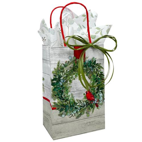 White kraft paper shopping bags with green wreath and red cardinal, red twisted handles