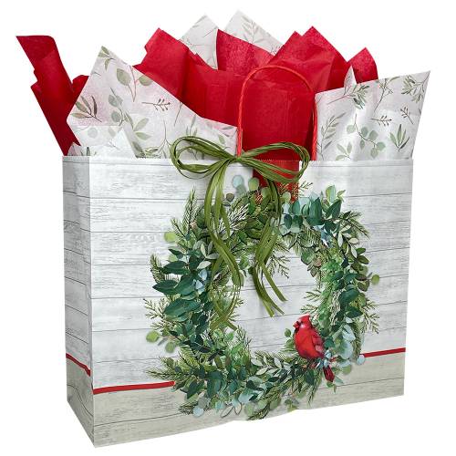 White kraft paper shopping bags with green wreath and red cardinal, red twisted handles