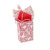 Pink paper shopping bag printed with frosted Christmas tree cake snacks, green and red stars and white snowflakes, with white twisted-paper handles