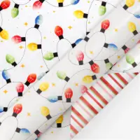 Colorful Christmas bulb lights and gold stars on white gift wrap. Reverses to a pink and red stripe. 24 in. half ream roll.