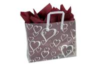 Scattered heart-outline print on a frosted clear poly shopping bag with soft loop handles — 16 x 6 x 12