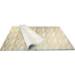 Golden wood grain printed tissue paper with metallic woodgrain pattern on a light background