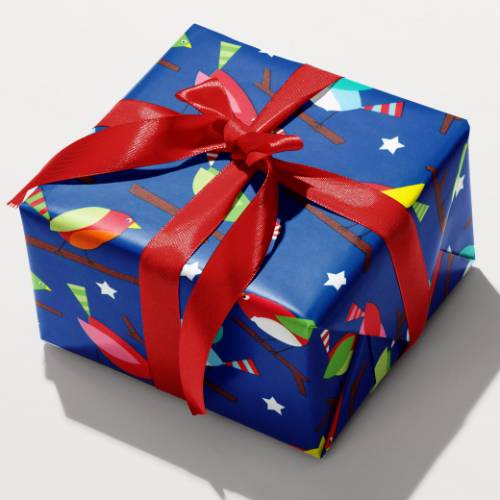 Royal blue holiday gift wrap with colorful mid century style birds on branches among striped trees and white stars