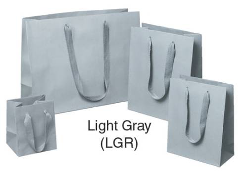 Light gray Manhattan shopping bags in matte uncoated paper with flat woven cotton-twill handles, shown in multiple sizes