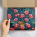 Pretty Poppies printed tissue paper lining a shipping box with a gold seal