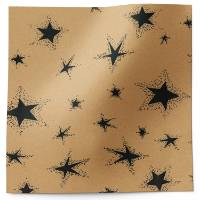 Primitive-style black star tissue paper with hand-stamped stars in varying sizes on a warm kraft background