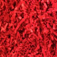 Close-up of bright red crinkle cut paper shred, tightly crimped zig-zag paper strands for gift basket and box fill