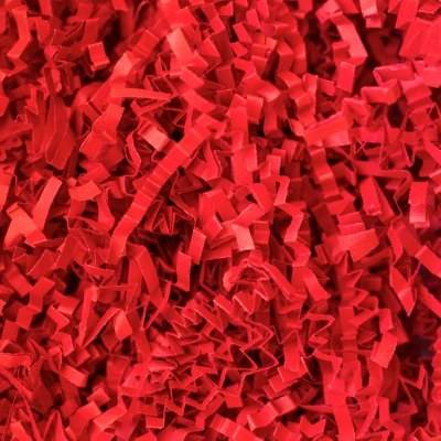Close-up of bright red crinkle cut paper shred, tightly crimped zig-zag paper strands for gift basket and box fill