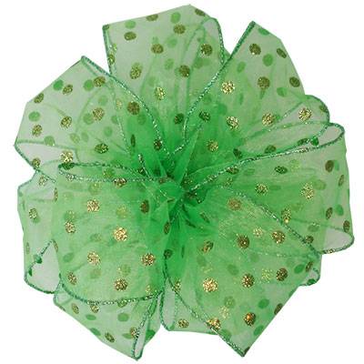 Sheer lime green wired ribbon formed into an airy bow, covered in green and gold glitter polka dots with glitter edges