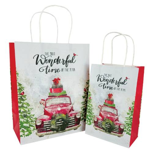 Kraft paper shopping bags with twisted paper handles featuring vintage red truck holiday print with green trees
