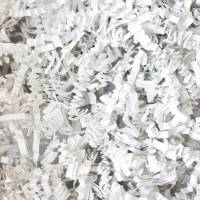 Close-up of white crinkle cut paper shred, crisp bright white zig-zag paper strands for gift basket and box fill