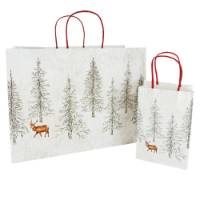 Kraft paper shopping bags with twisted paper handles featuring winter forest print with snow and evergreen trees
