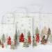 White kraft paper shopping bag with winter wonderland holiday print, twisted paper handles