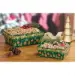 Cozy ornaments market trays styled as finished holiday gift baskets with pine sprigs, pinecones and red berries