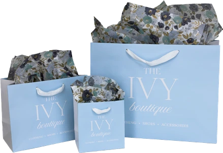 Custom printed shopping bags for The Ivy Boutique in powder blue with a white logo