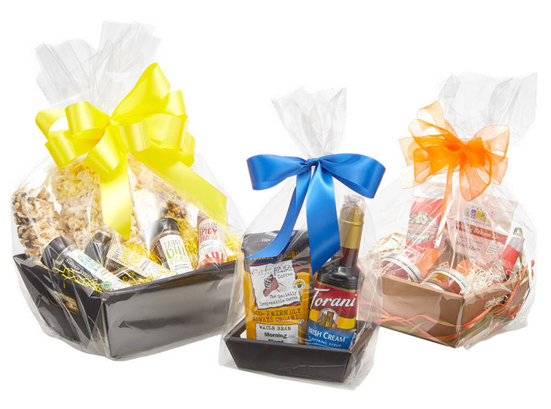 Clear basket bags — gift baskets wrapped in clear cellophane bags and tied with colorful bows