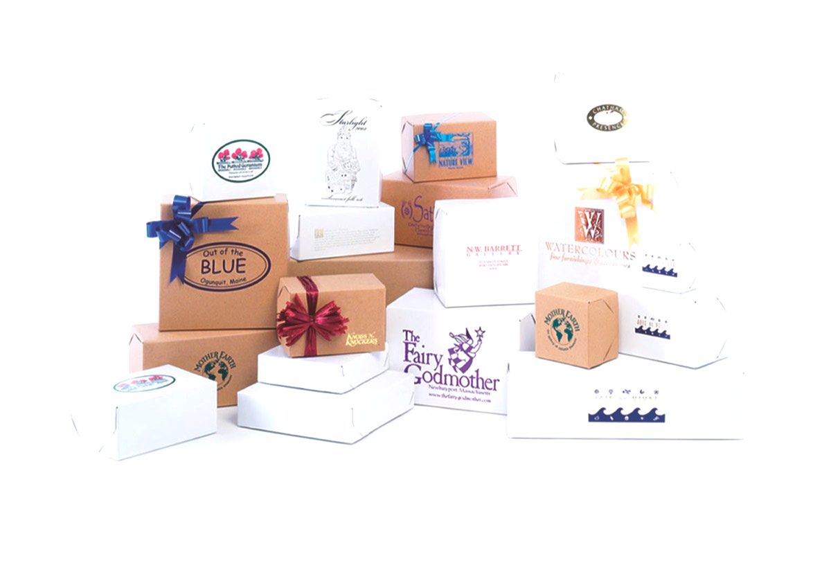 White gloss and natural kraft two-piece lock corner gift boxes in graduated sizes, custom printed with store logos