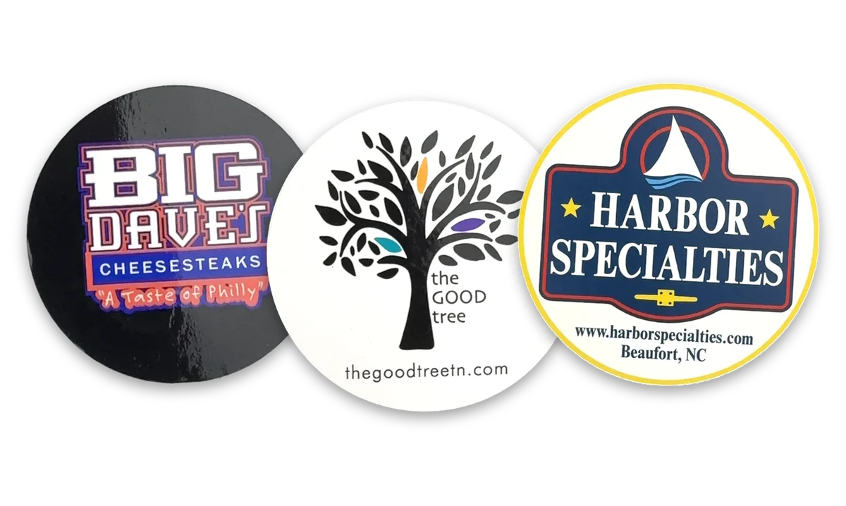 Full color digitally printed labels supplied to customers: a black cheesesteak shop circle, a tree logo on a white circle and a navy, red and yellow seal