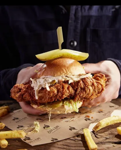 Fried chicken sandwich served on branded deli paper