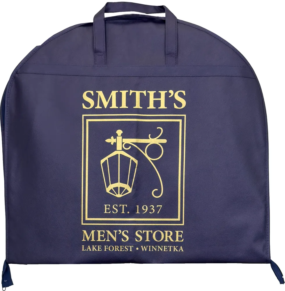 The same garment bag folded in half and carried by its two loop handles, logo facing out