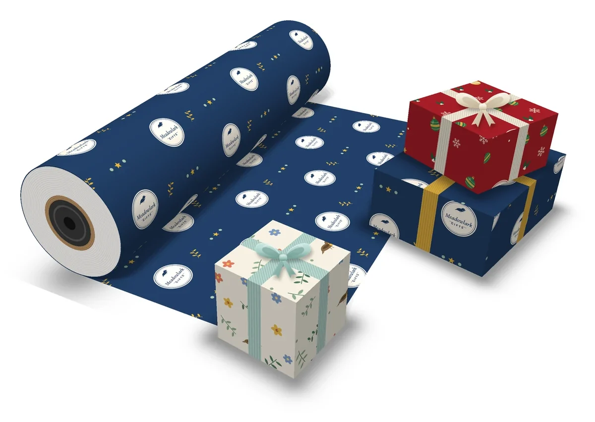 Counter roll of navy custom printed gift wrap with a store logo repeat, pulled out across the counter beside gifts wrapped in custom paper