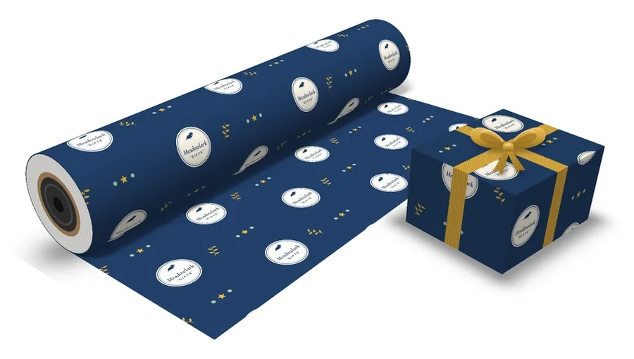 Navy custom gift wrap with a round store logo repeated across the roll and on a wrapped box with a gold ribbon