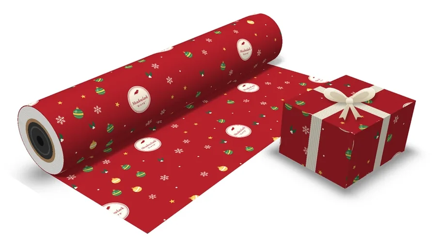 Red holiday custom gift wrap with snowflakes, ornaments, holly and a store logo, on a roll and a wrapped box with a cream ribbon