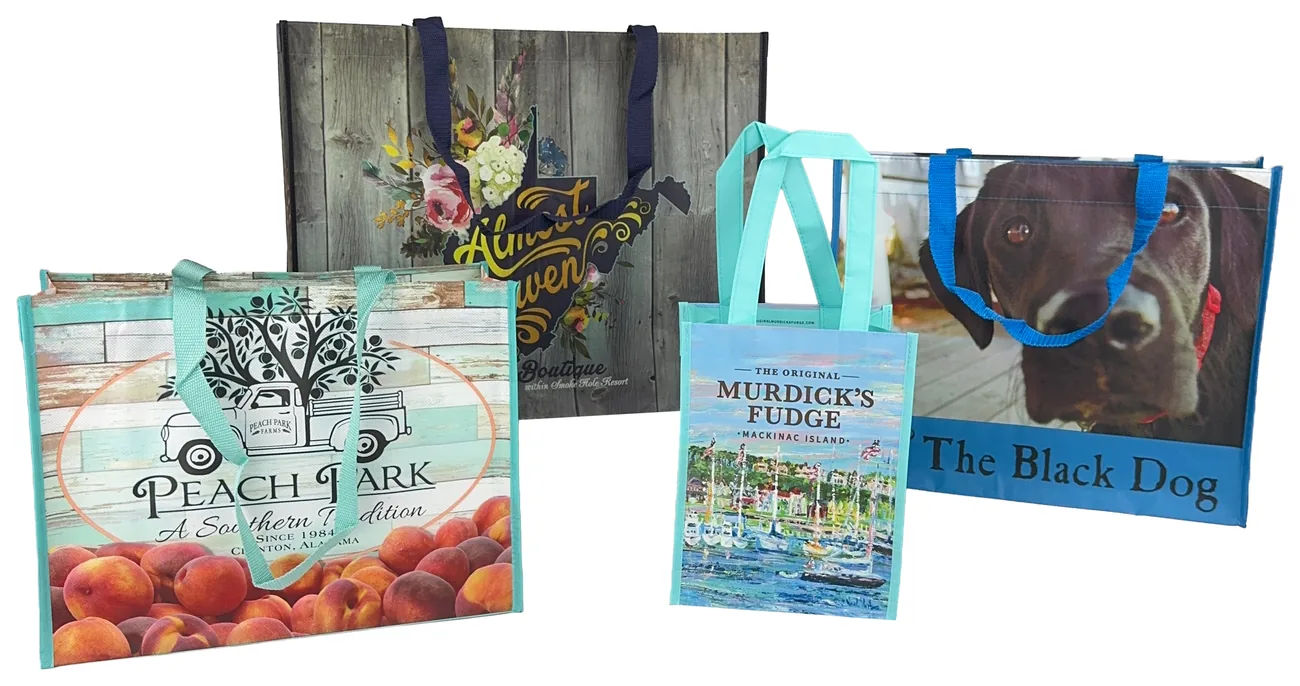 Four custom laminated non-woven tote bags printed edge to edge in full color for a peach farm, a boutique, a fudge shop and a dog themed store