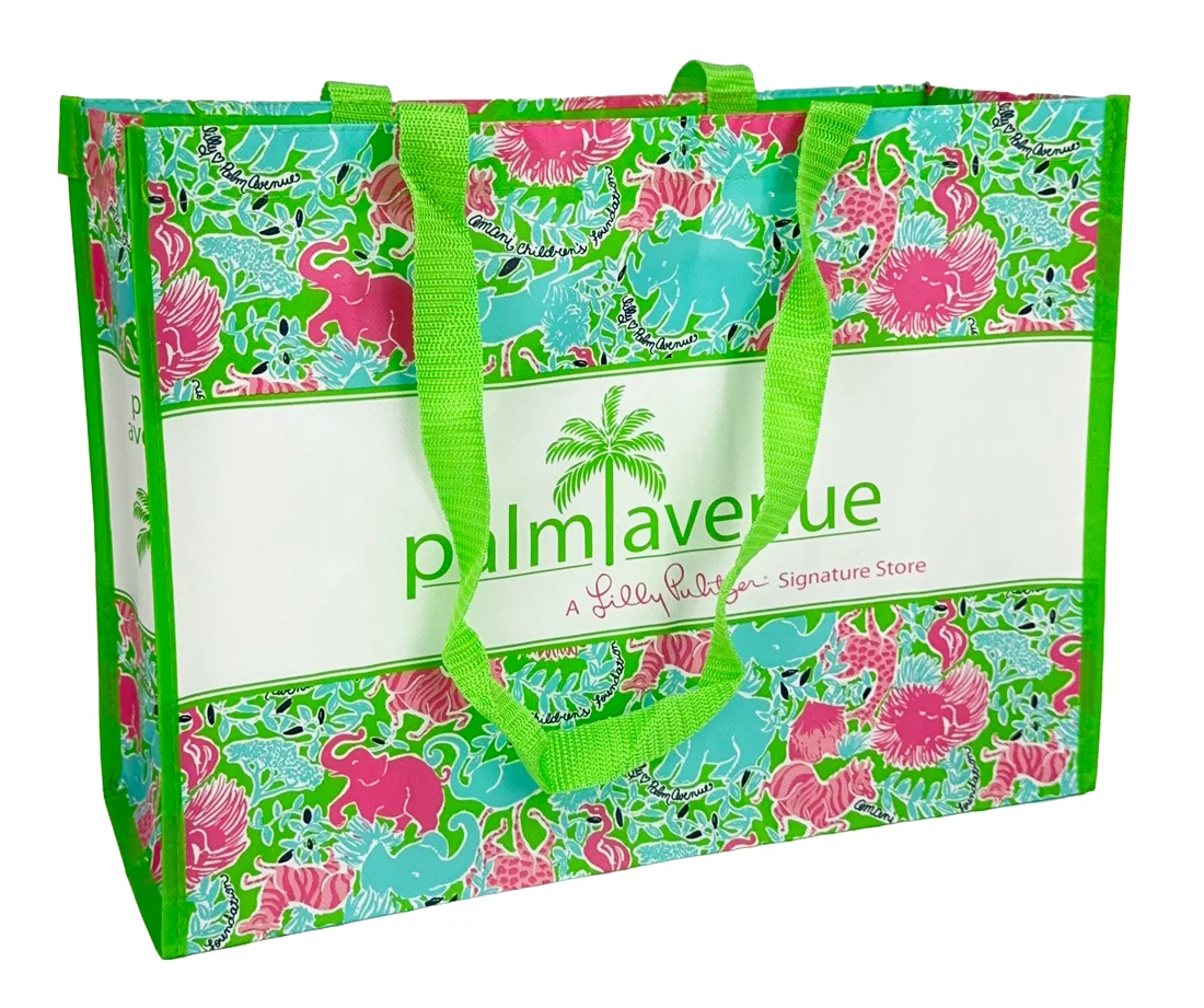 Custom laminated tote bag printed edge to edge with a full color signature pattern in green and pink