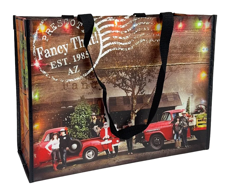 Laminated non-woven tote printed with a full color holiday photograph including string lights and a red truck