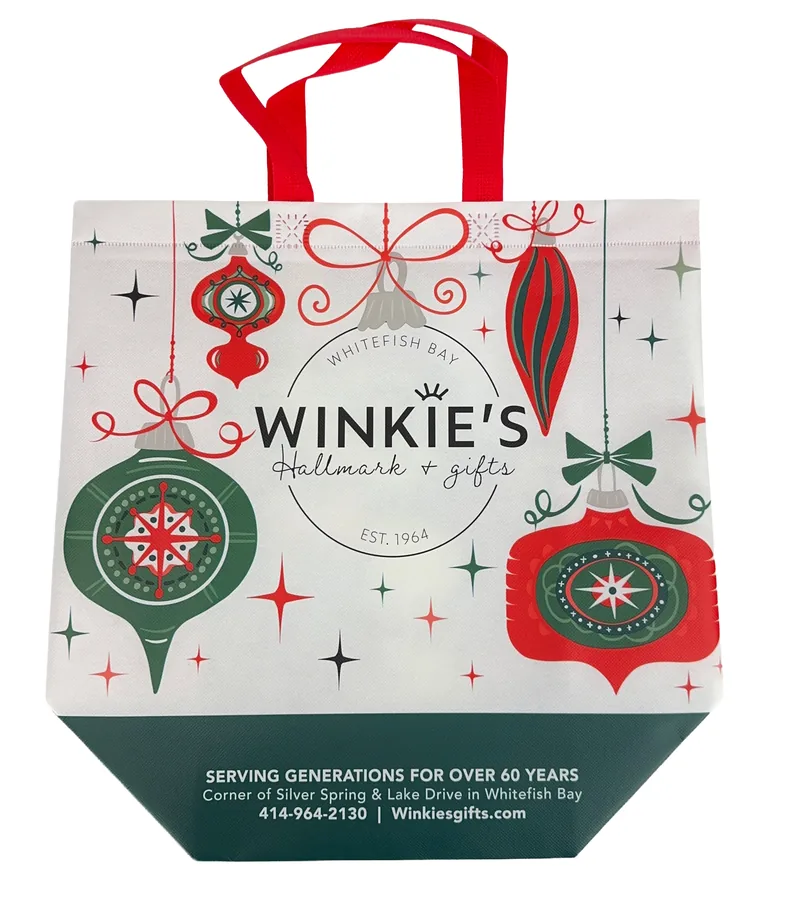 Heat sealed laminated tote printed with a red and green holiday ornament design for a gift shop
