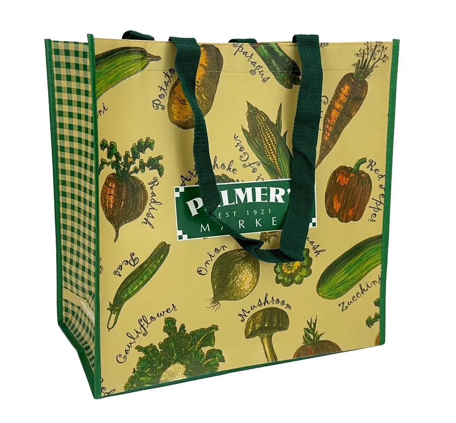 Laminated grocery tote printed edge to edge with a vegetable illustration pattern and gingham gussets