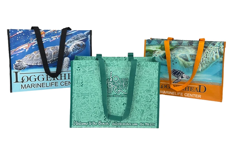 Three custom laminated tote bags printed edge to edge in full color with sea turtle photographs and a pattern