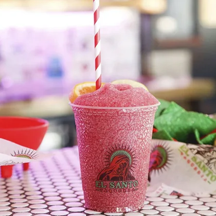 Custom printed clear plastic cup with a frozen red drink for a taqueria