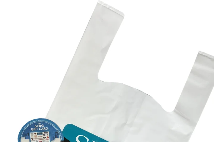 Close up of the two loop handles on a white t-shirt plastic bag