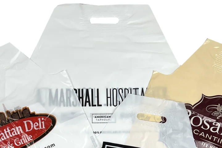 Close up of the raised wave top and die cut handle on a white carry out bag