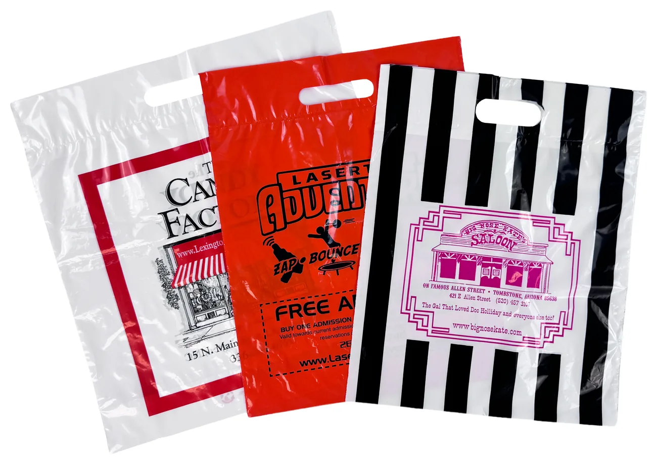 Three custom printed fold over die cut plastic bags: a white bag with a red border, a red bag printed in black and a black and white striped bag with a magenta logo