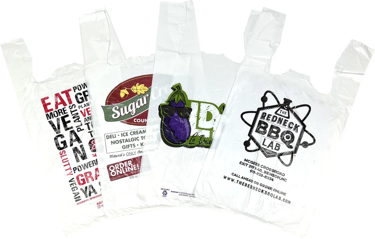 Four custom printed white t-shirt plastic bags with restaurant, bakery, farm market and barbecue logos in one to four ink colors