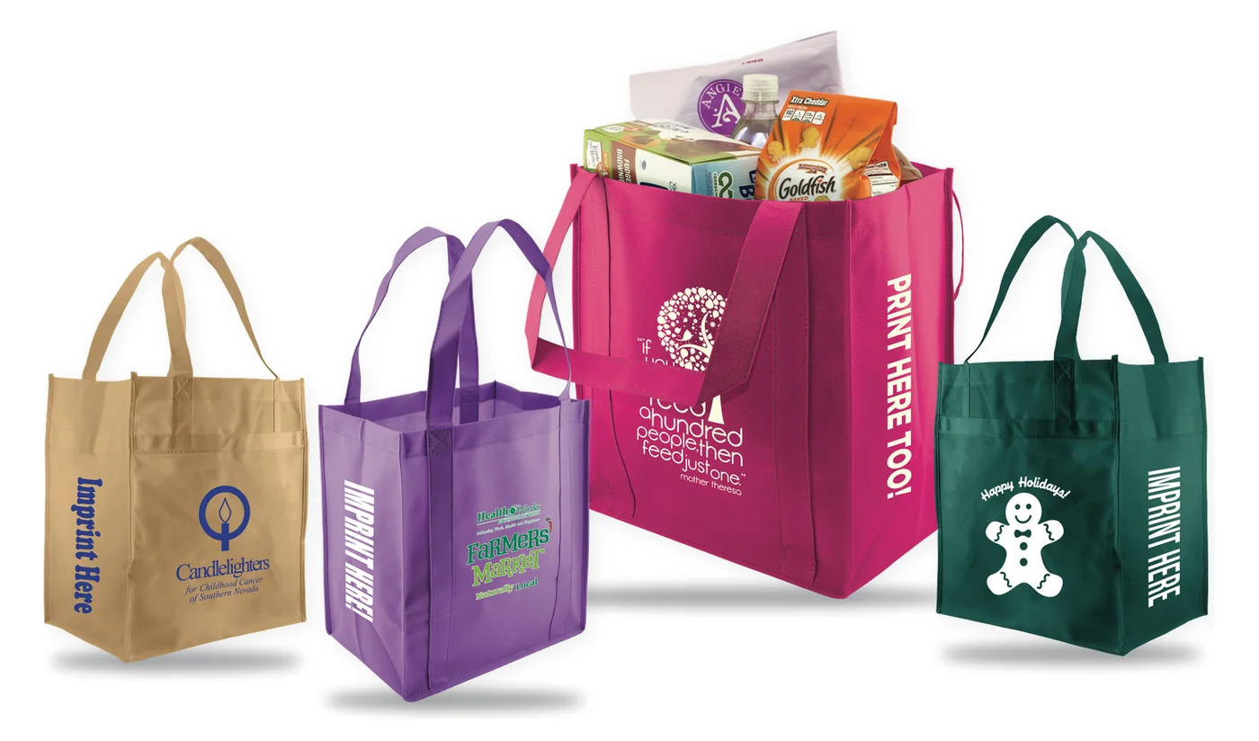 Four custom printed non-woven grocery tote bags in natural, purple, hot pink and dark green, each silkscreened with a store logo on the front and the side gusset