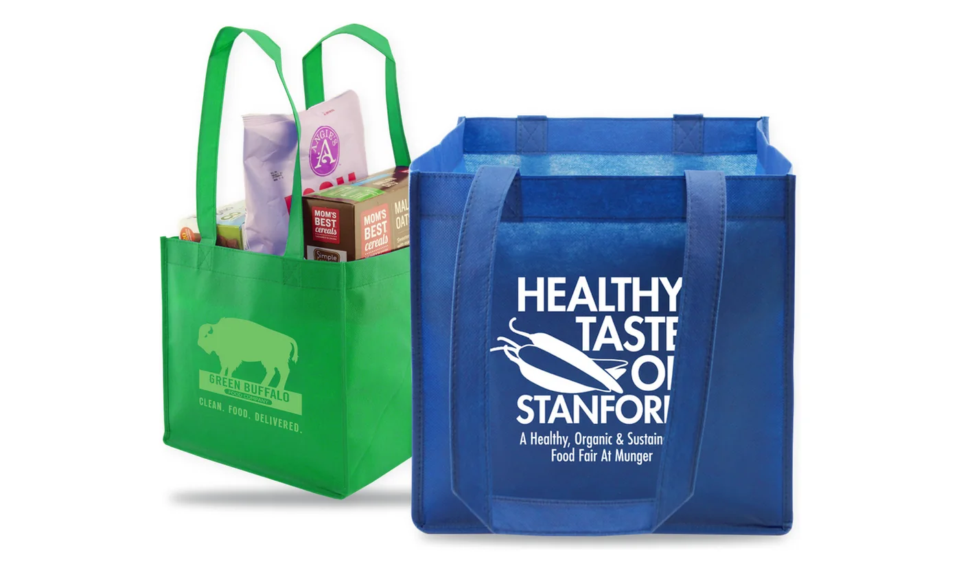 Two custom printed square non-woven totes, a kelly green tote packed with groceries and a royal blue tote with a white logo