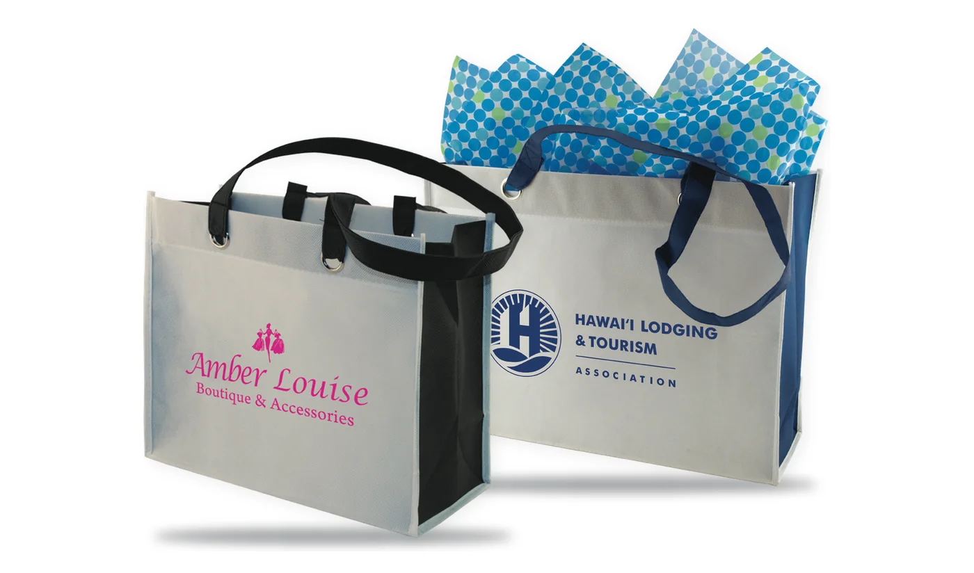 Two custom printed two tone boutique totes with silver metal grommets, one with a lodging association logo and tissue, one with a boutique logo