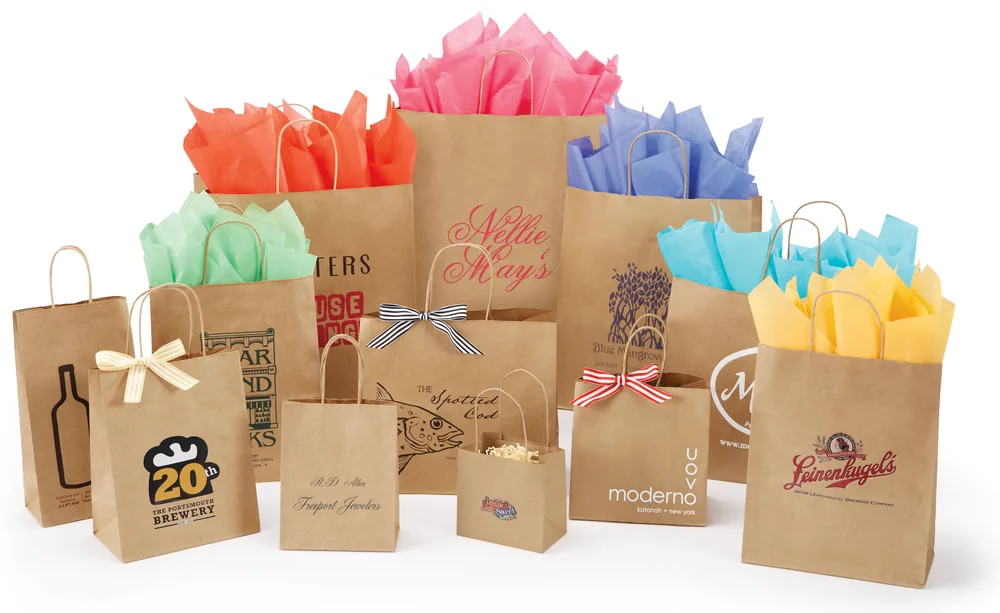 Natural kraft twisted handle shopping bags in fourteen sizes, ink printed with customer logos and filled with colored tissue
