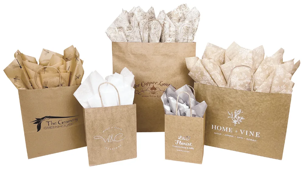Natural kraft fold-over J-Cut shopping bags with printed logos and tissue paper