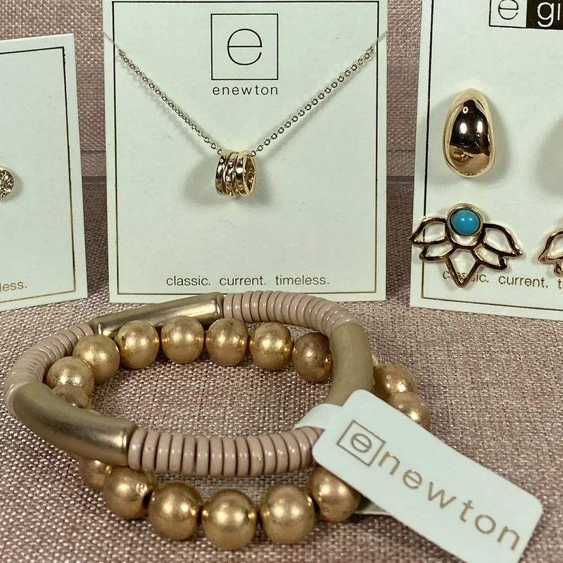 Necklace card and foldover bracelet card with hot-stamped brand logo, shown with gold jewelry