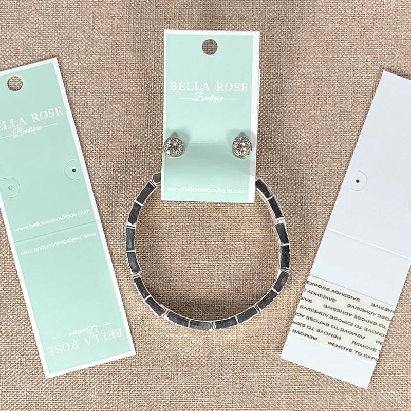 Mint and white combo cards holding earring and bracelet sets with printed boutique logos