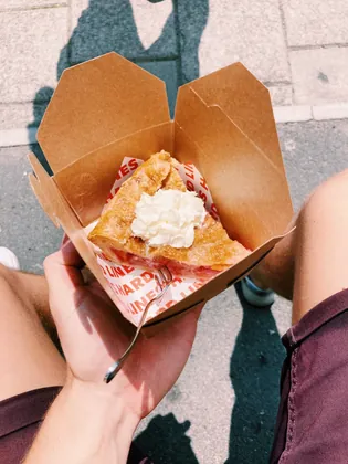 Fried chicken in a box lined with printed wax paper